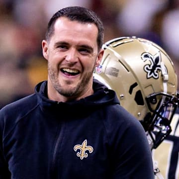 New Orleans Saints quarterback Derek Carr reacts to a play while on the sidelines.