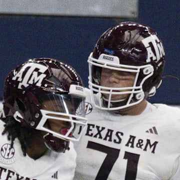 Sep 30, 2023; Arlington, Texas, USA; Texas A&M Aggies running back Earnest Crownover (24) and offensive lineman Chase Bisontis (71) celebrate after Crownover scores a touchdown against the Arkansas Razorbacks during the first half at AT&T Stadium. Mandatory Credit: Jerome Miron-Imagn Images