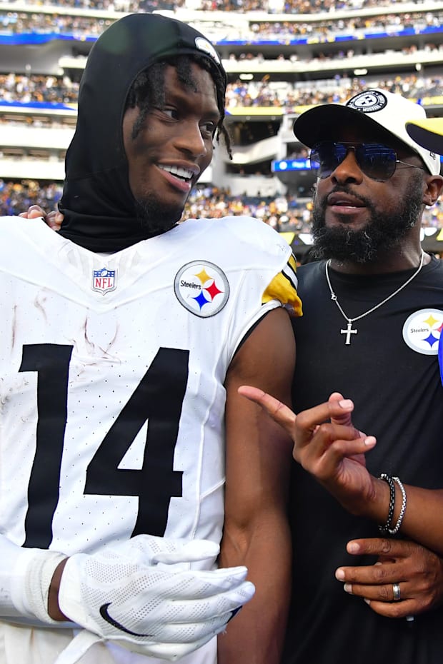 Pittsburgh Steelers wide receiver George Pickens (14) and head coach Mike Tomlin meet with Los Angeles Rams