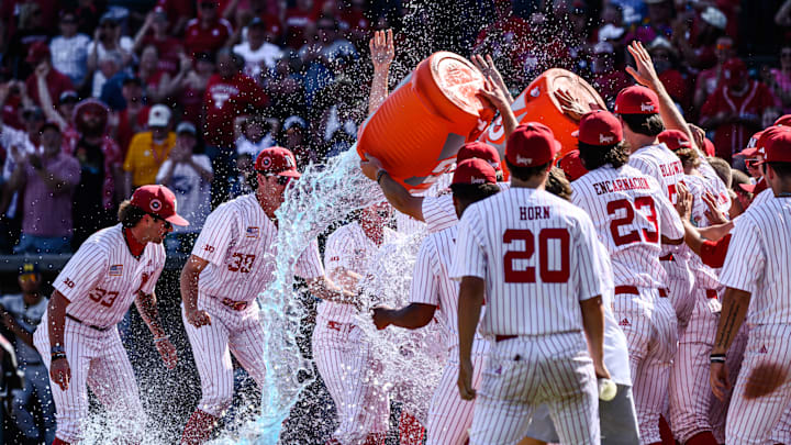 The Huskers splash Case Sanderson as he gets to home plate. 