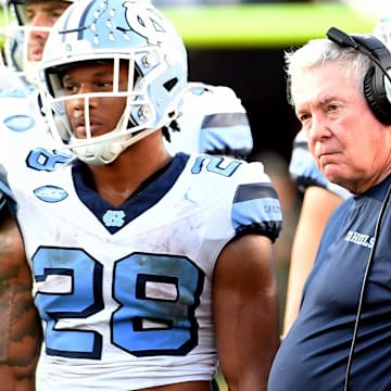 North Carolina Tar Heels head coach Mack Brown looks on with his players during an injury time out in the third quarter against the Florida State Seminoles.