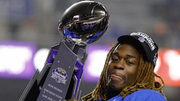 Ashton Jeanty hoists the Mountain West trophy. 