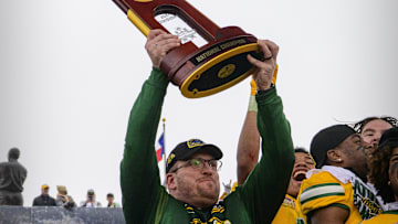 Jan 8, 2022; Frisco, TX, USA; North Dakota State Bison head coach Matt Entz holds up the championship trophy as the North Dakota State Bison team celebrates the win over the Montana State Bobcats in the FCS Championship at Toyota Stadium. Mandatory Credit: Jerome Miron-Imagn Images