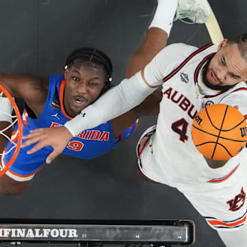 Apr 5, 2025; San Antonio, TX, USA;  Auburn Tigers forward Johni Broome (4) shoots against Florida Gators center Rueben Chinyelu (9) in the semifinals of the men's Final Four of the 2025 NCAA Tournament at the Alamodome. Mandatory Credit: Robert Deutsch-Imagn Images