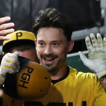Jun 6, 2025; Pittsburgh, Pennsylvania, USA;  Pittsburgh Pirates right fielder Bryan Reynolds (10) celebrates his  solo home run in the dugout against the Philadelphia Phillies during the third inning at PNC Park. Mandatory Credit: Charles LeClaire-Imagn Images