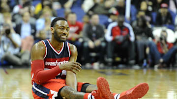 Dec 6, 2015; Washington, DC, USA; Washington Wizards guard John Wall (2) grimaces after suffering an apparent leg injury  during the second half at Verizon Center. Dallas Mavericks won 116 - 104. Mandatory Credit: Brad Mills-Imagn Images