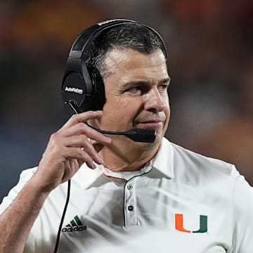 Dec 28, 2024; Orlando, FL, USA; Miami Hurricanes head coach Mario Cristobal walks on the field during the second half against the Iowa State Cyclones at Camping World Stadium. Mandatory Credit: Jasen Vinlove-Imagn Images