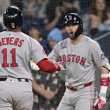 Apr 30, 2025; Toronto, Ontario, CAN; Boston Red Sox shortstop Trevor Story (10) congratulates designated hitter Rafael Devers (11) after he scores on a walk by the Toronto Blue Jays during the first inning at Rogers Centre. Mandatory Credit: John E. Sokolowski-Imagn Images