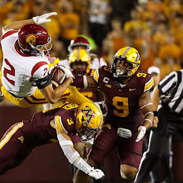 Oct 5, 2024; Minneapolis, Minnesota, USA; Minnesota Golden Gophers defensive back Koi Perich (3) tackles USC Trojans wide receiver Duce Robinson (2) during the second half at Huntington Bank Stadium. Mandatory Credit: Matt Krohn-Imagn Images