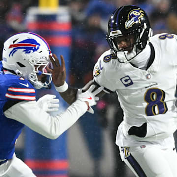 Baltimore Ravens quarterback Lamar Jackson runs the ball against Buffalo Bills cornerback Taron Johnson.