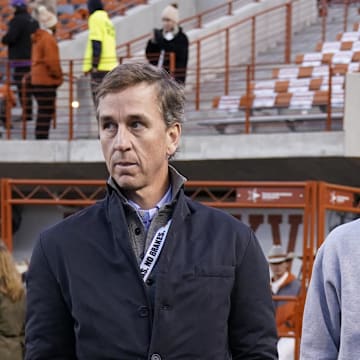Manning (right) was already the apple of college football coaches' eyes before he even had braces. 