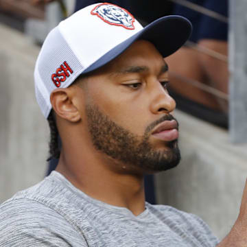 Aug 1, 2024; Canton, Ohio, USA;  Chicago Bears defensive end Montez Sweat (98) signs autographs before the game against the Houston Texans at Tom Benson Hall of Fame Stadium. Mandatory Credit: Charles LeClaire-Imagn Images