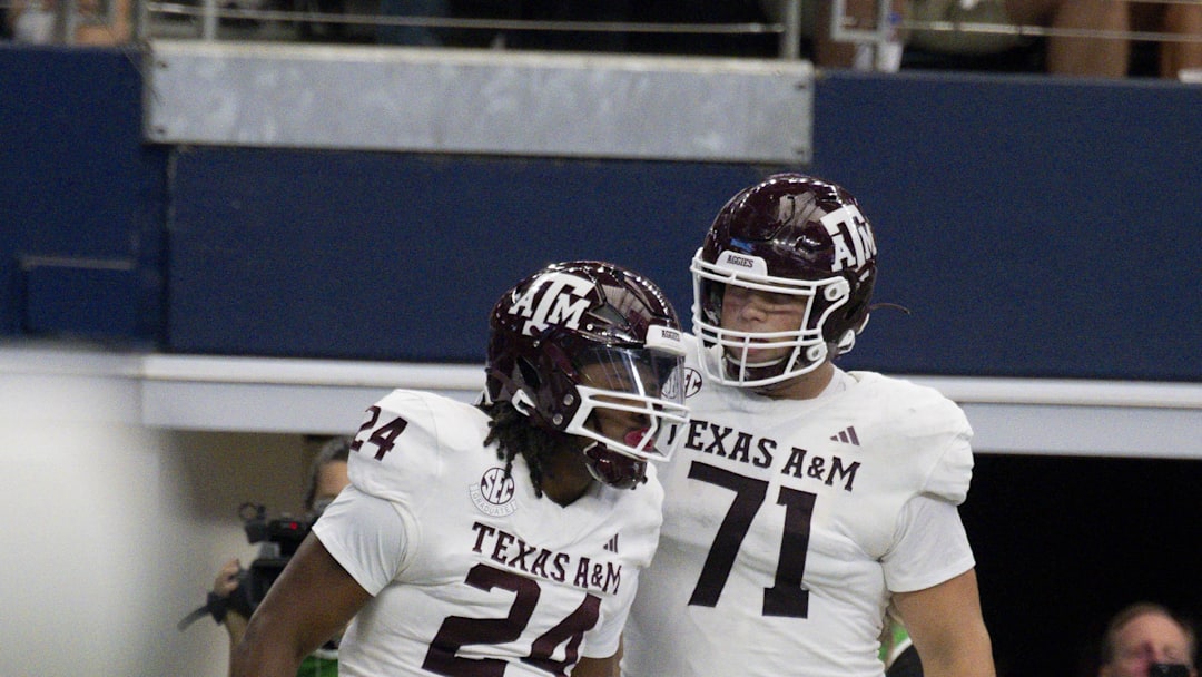 Sep 30, 2023; Arlington, Texas, USA; Texas A&M Aggies running back Earnest Crownover (24) and offensive lineman Chase Bisontis (71) celebrate after Crownover scores a touchdown against the Arkansas Razorbacks during the first half at AT&T Stadium. Mandatory Credit: Jerome Miron-Imagn Images Sep 30, 2023; Arlington, Texas, USA; Texas A&M Aggies running back Earnest Crownover (24) and offensive lineman Chase Bisontis (71) celebrate after Crownover scores a touchdown against the Arkansas Razorbacks during the first half at AT&T Stadium. Mandatory Credit: Jerome Miron-Imagn Images