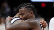 Marquette’s Kam Jones teammate David Joplin after losing to New Mexico in the first round of the NCAA tournament. 