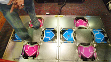 A player dances on the DDR or Dance Dance Revolution video game.