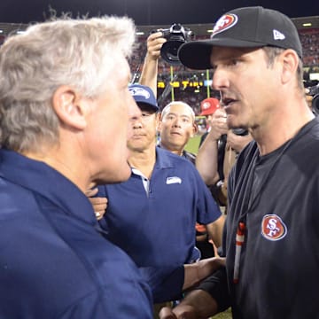 Seattle Seahawks coach Pete Carroll shakes hands with San Francisco 49ers coach Jim Harbaugh after the game at Candlestick Park. The 49ers defeated the Seahawks 13-6.  