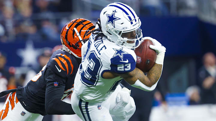 Dec 9, 2024; Arlington, Texas, USA; Dallas Cowboys running back Rico Dowdle (23) runs with the ball as Cincinnati Bengals cornerback DJ Ivey (38) defends during the first quarter at AT&T Stadium. Mandatory Credit: Kevin Jairaj-Imagn Images Dec 9, 2024; Arlington, Texas, USA; Dallas Cowboys running back Rico Dowdle (23) runs with the ball as Cincinnati Bengals cornerback DJ Ivey (38) defends during the first quarter at AT&T Stadium. Mandatory Credit: Kevin Jairaj-Imagn Images