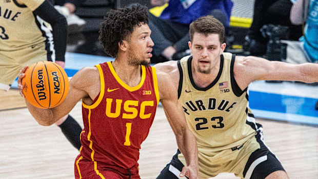 Mar 13, 2025; Indianapolis, IN, USA; USC Trojans guard Desmond Claude (1) passes the ball while Purdue Boilermakers forward C