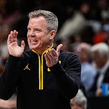 Michigan head coach Dusty May cheers 