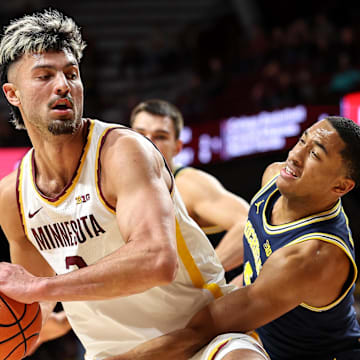 Jan 16, 2025; Minneapolis, Minnesota, USA; Minnesota Golden Gophers forward Dawson Garcia (3) works around Michigan Wolverines guard Nimari Burnett (4) during the first half at Williams Arena. Mandatory Credit: Matt Krohn-Imagn Images