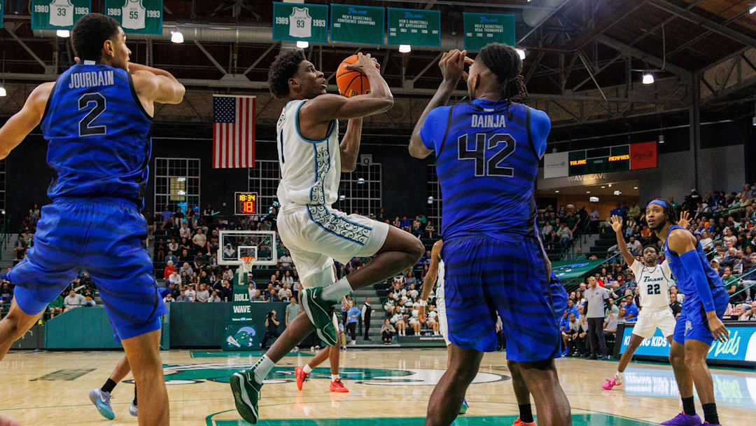 Jan 30, 2025; New Orleans, Louisiana, USA;  Tulane Green Wave forward Kaleb Banks (1) drives to the basket against Memphis Tigers forward Dain Dainja (42) during the second half at Avron B. Fogelman Arena in Devlin Fieldhouse.