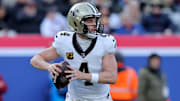 Dec 8, 2024; East Rutherford, New Jersey, USA; New Orleans Saints quarterback Derek Carr (4) drops back to pass against the New York Giants during the first quarter at MetLife Stadium. Mandatory Credit: Brad Penner-Imagn Images