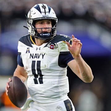 Dec 14, 2024; Landover, Maryland, USA; Navy Midshipmen quarterback Blake Horvath (11) looks to pass against the Army Black Knights during the first half of the the 125th Army-Navy game at Northwest Stadium. Mandatory Credit: Danny Wild-Imagn Images