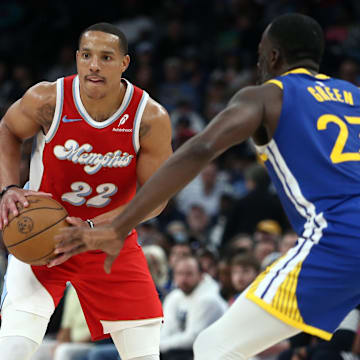 Apr 1, 2025; Memphis, Tennessee, USA; Memphis Grizzlies guard Desmond Bane (22) handles the ball as Golden State Warriors forward Draymond Green (23) defends during the second quarter at FedExForum. Mandatory Credit: Petre Thomas-Imagn Images