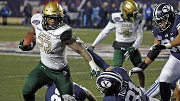 Dec 18, 2021; Shreveport, LA, USA; UAB Blazers running back DeWayne McBride (22) breaks a tackle against the BYU Cougars linebacker Max Tooley (31) during the fourth quarter during the 2021 Independence Bowl at Independence Stadium. Mandatory Credit: Petre Thomas-Imagn Images
