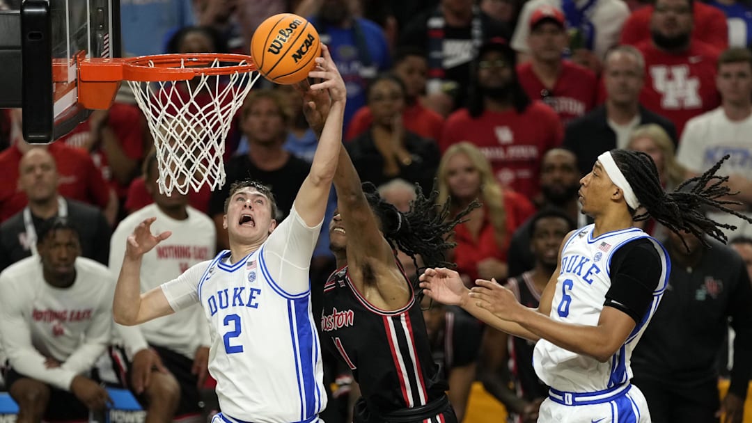 Apr 5, 2025; San Antonio, TX, USA; Duke Blue Devils forward Cooper Flagg (2) grabs a rebound over Houston Cougars forward Joseph Tugler (11) during the second half in the semifinals of the men's Final Four of the 2025 NCAA Tournament at Alamodome. Mandatory Credit: Scott Wachter-Imagn Images
