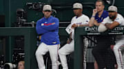 Arlington, Texas, USA; Texas Rangers hitting coach Bret Boone stands at the end of the dugout with third base coach Tony Beasley (27) during the first inning against the Houston Astros at Globe Life Field.