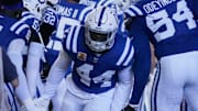 Indianapolis Colts linebacker Zaire Franklin (44) high fives his teammates as he takes the field Sunday, Oct. 20, 2024, during a game against the Miami Dolphins at Lucas Oil Stadium in Indianapolis.
