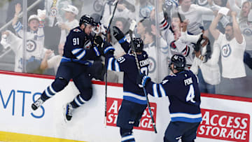 May 4, 2025; Winnipeg, Manitoba, CAN; Winnipeg Jets center Cole Perfetti (91) celebrates after his goal against the St. Louis Blues with teammates left wing Kyle Connor (81) and defenseman Neal Pionk (4) in the third period in game seven of the first round of the 2025 Stanley Cup Playoffs at Canada Life Centre. Mandatory Credit: James Carey Lauder-Imagn Images