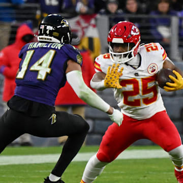 Jan 28, 2024; Baltimore, Maryland, USA; Kansas City Chiefs running back Clyde Edwards-Helaire (25) runs with the ball against Baltimore Ravens safety Kyle Hamilton (14) during the second half in the AFC Championship football game at M&T Bank Stadium. Mandatory Credit: Tommy Gilligan-Imagn Images
