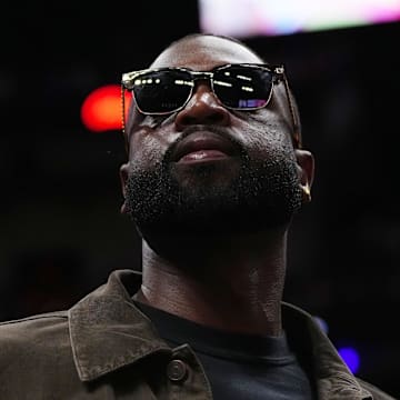 Jan 19, 2024; Miami, Florida, USA; Former Miami Heat player Dwayne Wade walks court-side during the second half of the game between the Miami Heat and the Atlanta Hawks at Kaseya Center. Mandatory Credit: Jasen Vinlove-Imagn Images