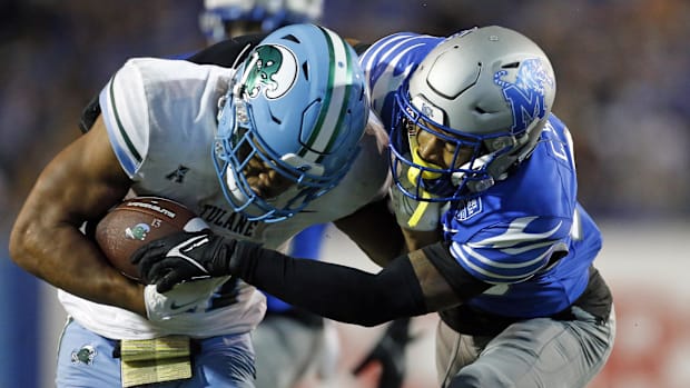 Tulane Green Wave running back Makhi Hughes (21) runs the ball as Memphis Tigers defensive back Cameron Smith (29)