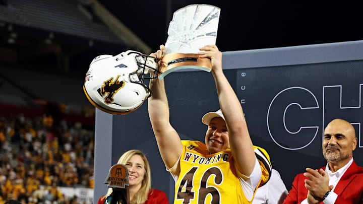 Wyoming Cowboys kicker John Hoyland celebrates with the MVP trophy after defeating the Toledo Rockets in the Arizona Bowl. Wyoming Cowboys kicker John Hoyland celebrates with the MVP trophy after defeating the Toledo Rockets in the Arizona Bowl.