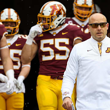 Nov 12, 2022; Minneapolis, Minnesota, USA; Minnesota Golden Gophers head coach P.J. Fleck leads his team out onto the field before the game against the Northwestern Wildcats at Huntington Bank Stadium. Mandatory Credit: Matt Krohn-Imagn Images