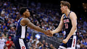 Arizona Wildcats guard Caleb Love (1) and forward Henri Veesaar (13) react during the first half against the Duke Blue Devils during an East Regional semifinal of the 2025 NCAA tournament at Prudential Center.