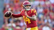 Nov 30, 2024; Los Angeles, California, USA; Southern California Trojans quarterback Jayden Maiava (14) throws against the Notre Dame Fighting Irish during the first half at the Los Angeles Memorial Coliseum. Mandatory Credit: Gary A. Vasquez-Imagn Images