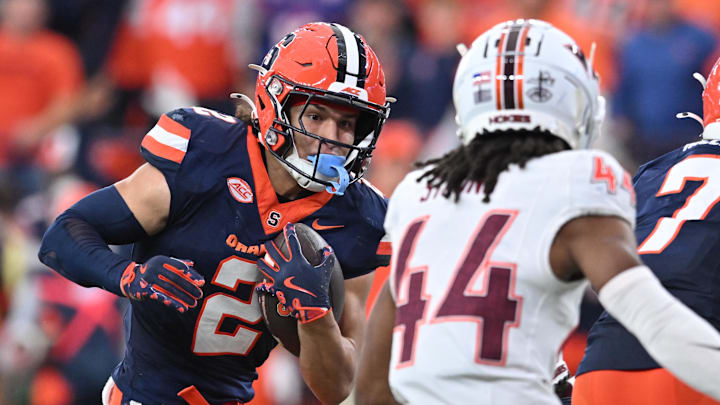 Nov 2, 2024; Syracuse, New York, USA; Syracuse Orange wide receiver Trebor Pena (2) tries to avoid a tackle by Virginia Tech Hokies cornerback Dorian Strong (44) in the third quarter at JMA Wireless Dome. Mandatory Credit: Mark Konezny-Imagn Images Nov 2, 2024; Syracuse, New York, USA; Syracuse Orange wide receiver Trebor Pena (2) tries to avoid a tackle by Virginia Tech Hokies cornerback Dorian Strong (44) in the third quarter at JMA Wireless Dome. Mandatory Credit: Mark Konezny-Imagn Images