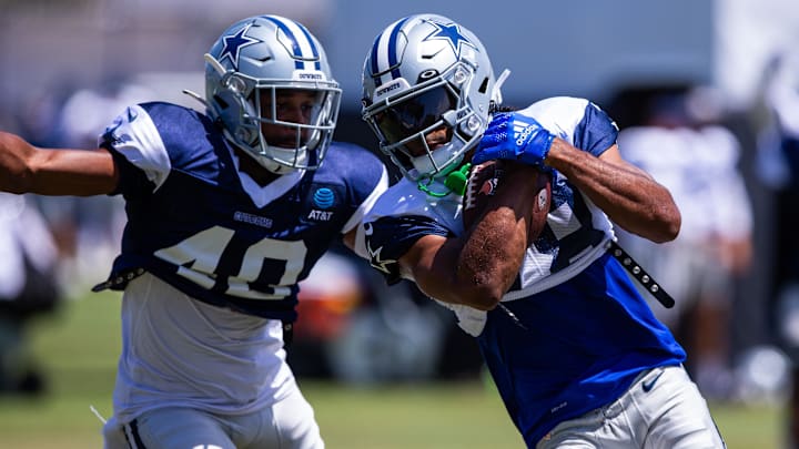Dallas Cowboys wide receiver Jalen Tolbert keeps the ball from safety Juanyeh Thomas during training camp. Dallas Cowboys wide receiver Jalen Tolbert keeps the ball from safety Juanyeh Thomas during training camp.