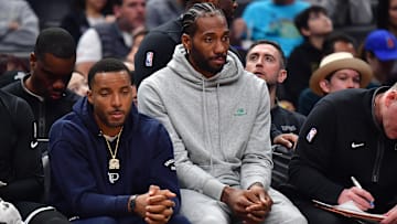 Mar 18, 2023; Los Angeles, California, USA; Los Angeles Clippers forward Kawhi Leonard (2) and forward Norman Powell (24) watch game action against the Orlando Magic during the first half at Crypto.com Arena. Mandatory Credit: Gary A. Vasquez-Imagn Images