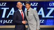 Jun 26, 2014; Brooklyn, NY, USA; Dante Exum (Australia) shakes hands with NBA commissioner Adam Silver after being selected as the number five overall pick to the Utah Jazz in the 2014 NBA Draft at the Barclays Center. Mandatory Credit: Brad Penner-Imagn Images