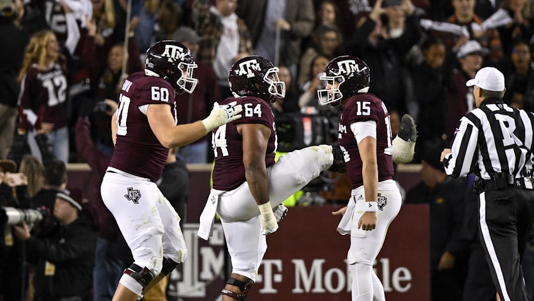 Nov 26, 2022; College Station, Texas, USA; Texas A&M Aggies quarterback Conner Weigman (15) and offensive lineman Layden Robinson (64) and offensive lineman Trey Zuhn III (60) celebrates a touchdown against the LSU Tigers during the second half at Kyle Field. Mandatory Credit: Jerome Miron-Imagn Images Nov 26, 2022; College Station, Texas, USA; Texas A&M Aggies quarterback Conner Weigman (15) and offensive lineman Layden Robinson (64) and offensive lineman Trey Zuhn III (60) celebrates a touchdown against the LSU Tigers during the second half at Kyle Field. Mandatory Credit: Jerome Miron-Imagn Images