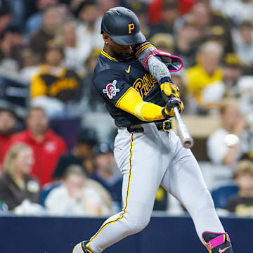 May 31, 2025; San Diego, California, USA; Pittsburgh Pirates designated hitter Andrew McCutchen (22) hits a single during the seventh inning against the San Diego Padres at Petco Park. Mandatory Credit: David Frerker-Imagn Images