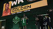 Receiver Matthew Golden of Texas poses after being selected with the 23rd overall pick by the Green Bay Packers.