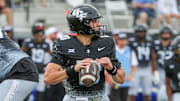 Nov 2, 2024; Orlando, Florida, USA; UCF Knights quarterback Dylan Rizk (10) drops back to throw against the Arizona Wildcats during the first quarter at FBC Mortgage Stadium. Mandatory Credit: Mike Watters-Imagn Images