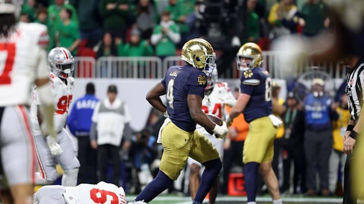 Notre Dame Fighting Irish running back Jeremiyah Love scores a two-point conversion against the Ohio State Buckeyes Notre Dame Fighting Irish running back Jeremiyah Love scores a two-point conversion against the Ohio State Buckeyes