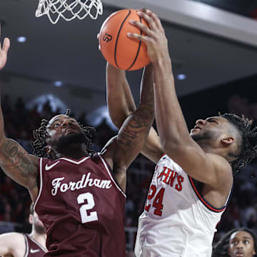 Nov 4, 2024; Queens, New York, USA;  Fordham Rams forward Romad Dean (2) and St. John's Red Storm forward Zuby Ejiofor (24) fight for a rebound in the second half at Carnesecca Arena. Mandatory Credit: Wendell Cruz-Imagn Images